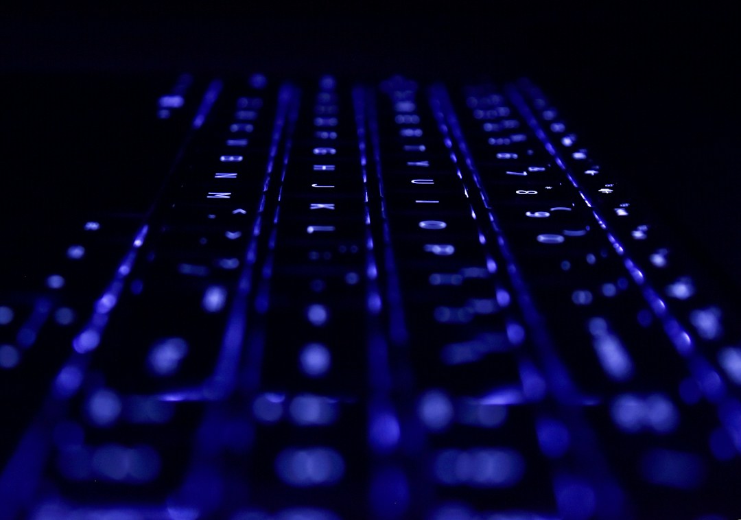 Rows of keyboard keys glowing blue in darkness