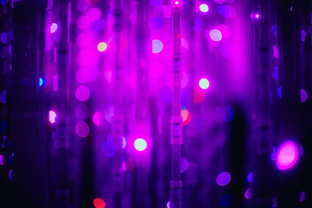 Vertical violet light strands with bright points of light