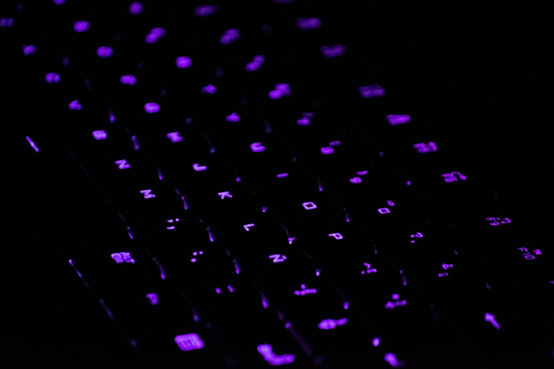 Computer keyboard dotted with violet backlights