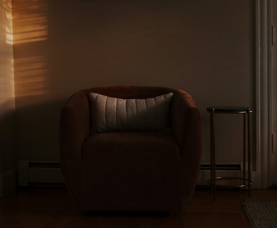 Empty brown armchair in a softly lit room