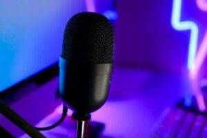 Microphone beside a laptop illustrating live cam audio and streaming setup