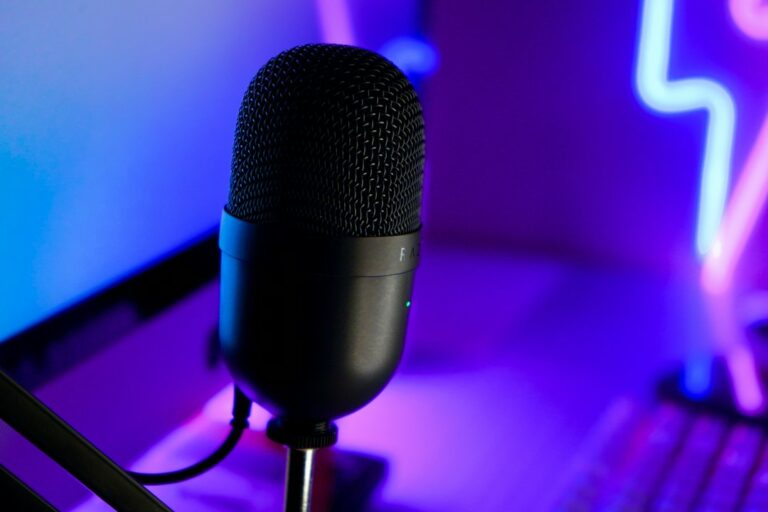 Microphone beside a laptop illustrating live cam audio and streaming setup