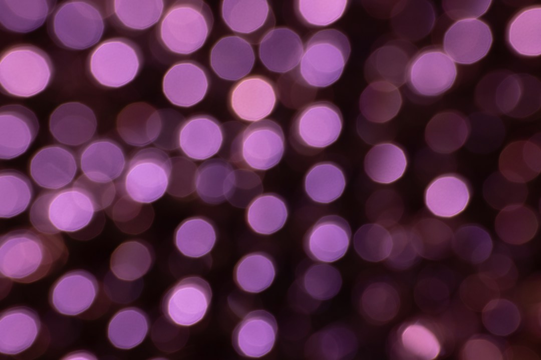 Soft purple circles of light against a dark background